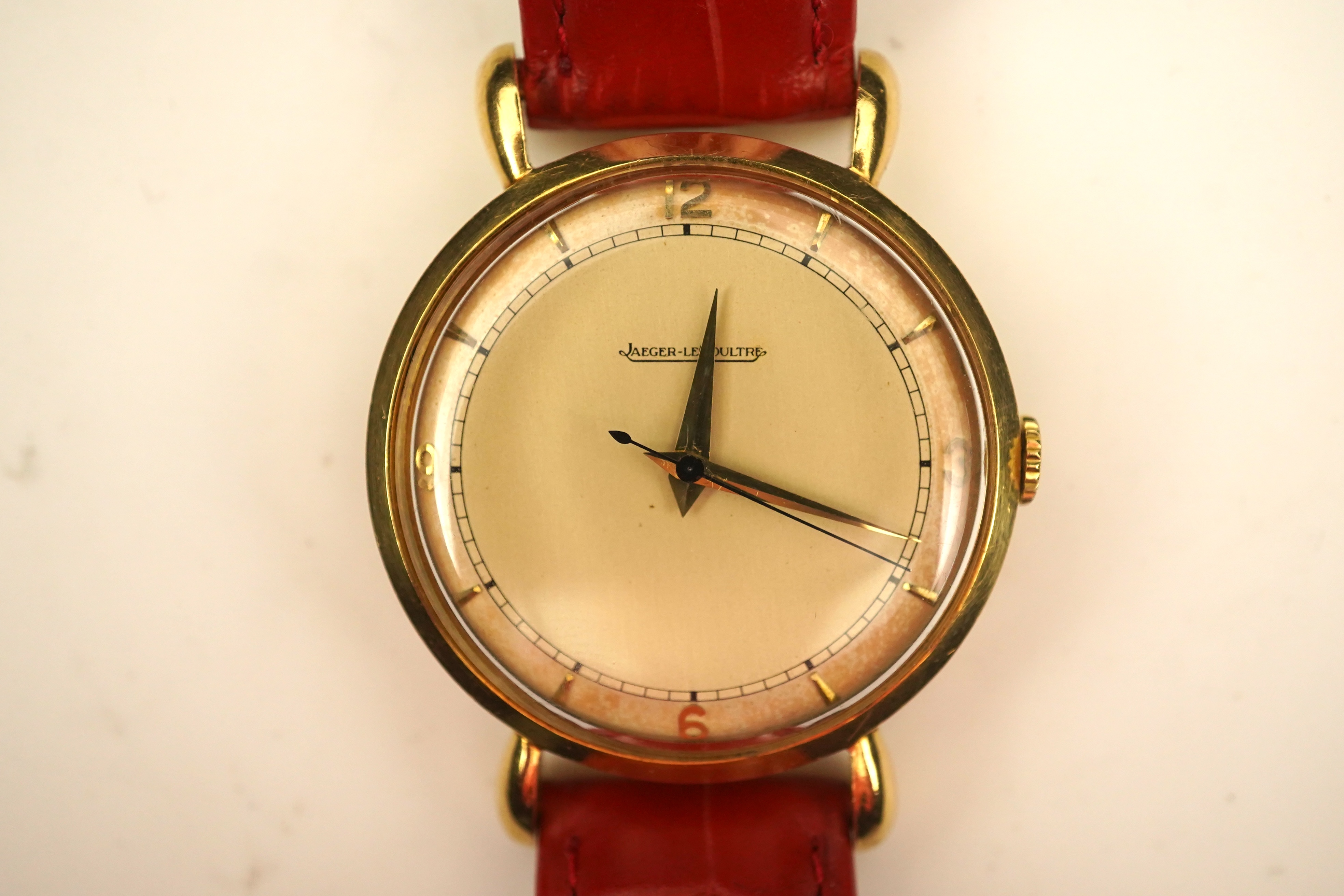 A gentleman's 1950's 18ct gold Jaeger LeCoultre manual wind wrist watch, on a later associated leather strap